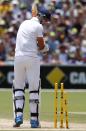 England's Stuart Broad looks at the stumps after he was bowled out by Australia's Mitchell Johnson during the third day's play in the second Ashes cricket test at the Adelaide Oval December 7, 2013.