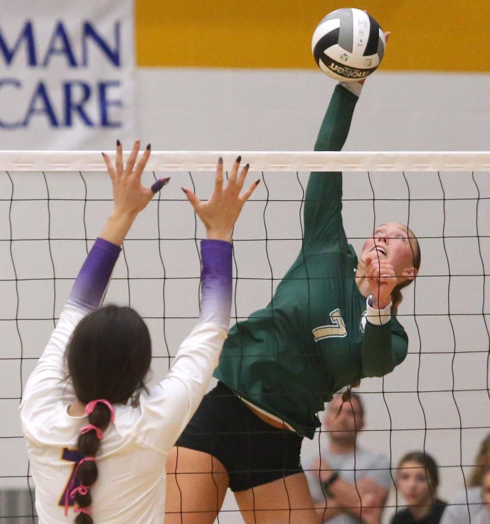 GlenOak's Natalie Stepanovich (right), shown here during a match against Jackson on Oct. 11, had 17 points and 22 kills in the Golden Eagles' Division I district semifinal win over Hoover on Tuesday.