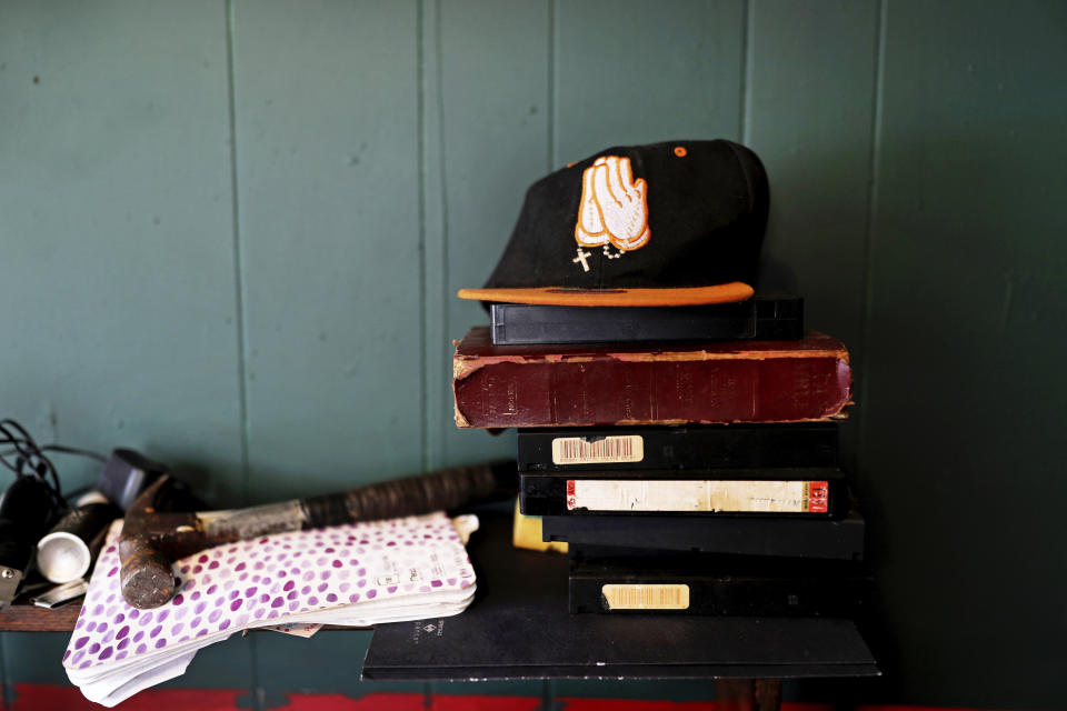 A cap embroidered with prayer hands sits on a shelf in Joshua K. Love's living room at his home in Greenwood, Miss., Saturday, June 8, 2019. Love says he prays and believes in God, even though he said he was sexually abused at a local Catholic grade school. (AP Photo/Wong Maye-E)