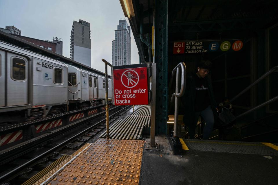 In this file photo taken on March 13, 2023 a warning sign is displayed at a subway station in New York. Authorities in New York are trying to raise awareness about the dangers of 'subway surfing' after a pair of deaths in June 2023.