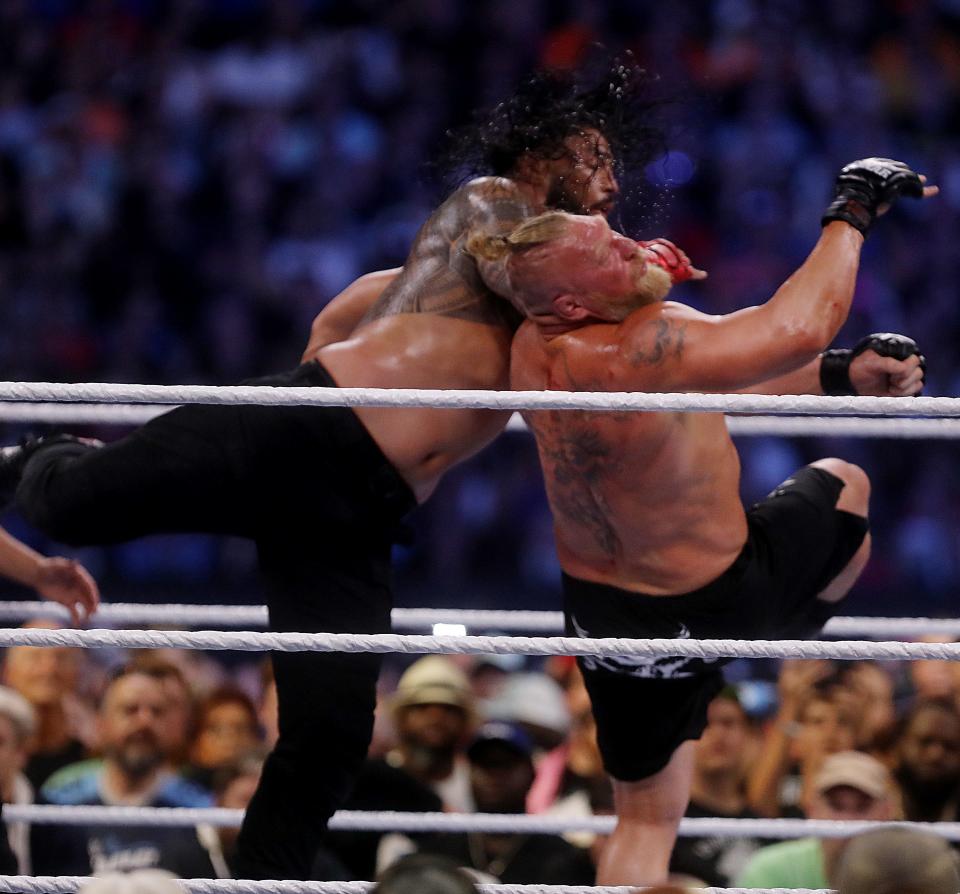 Roman Reigns and Brock Lesnar compete during the WWE SummerSlam at Nissasn Stadium in July.