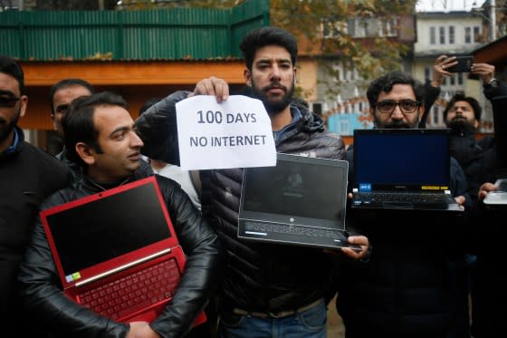 Kashmiri journalists hold placards and protest against 100 days of internet blockade in the region in Srinagar, Indian controlled Kashmir, on Nov. 12, 2019. Internet services have been cut since Aug. 5 when Indian-controlled Kashmir's semi-autonomous status was removed. <span class="copyright">Mukhtar Khan—AP</span>