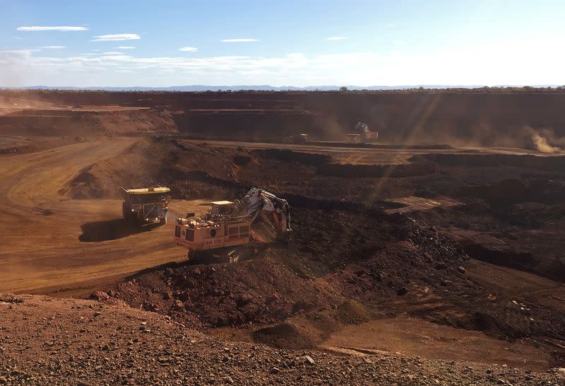 FILE PHOTO: An autonomous truck readies to pick up a load of iron ore at Australia's Fortescue Metals Group (FMG) Chichester Hub, which includes the Christmas Creek iron ore mine, in the Pilbara region