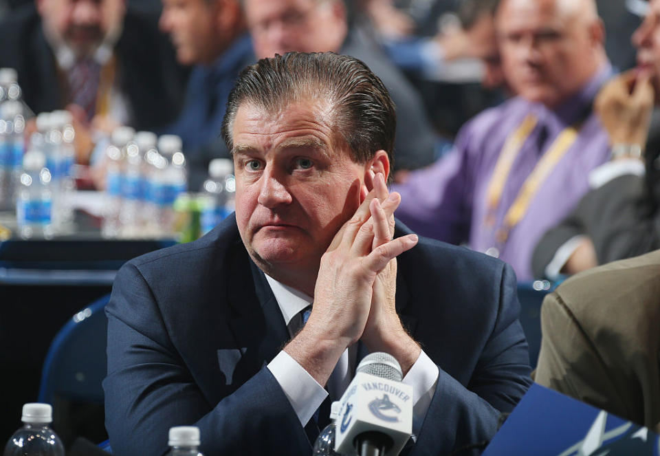 Jim Benning has done some dubious work, as the Canucks GM, but he has an extension in hand. (Bruce Bennett/Getty Images)