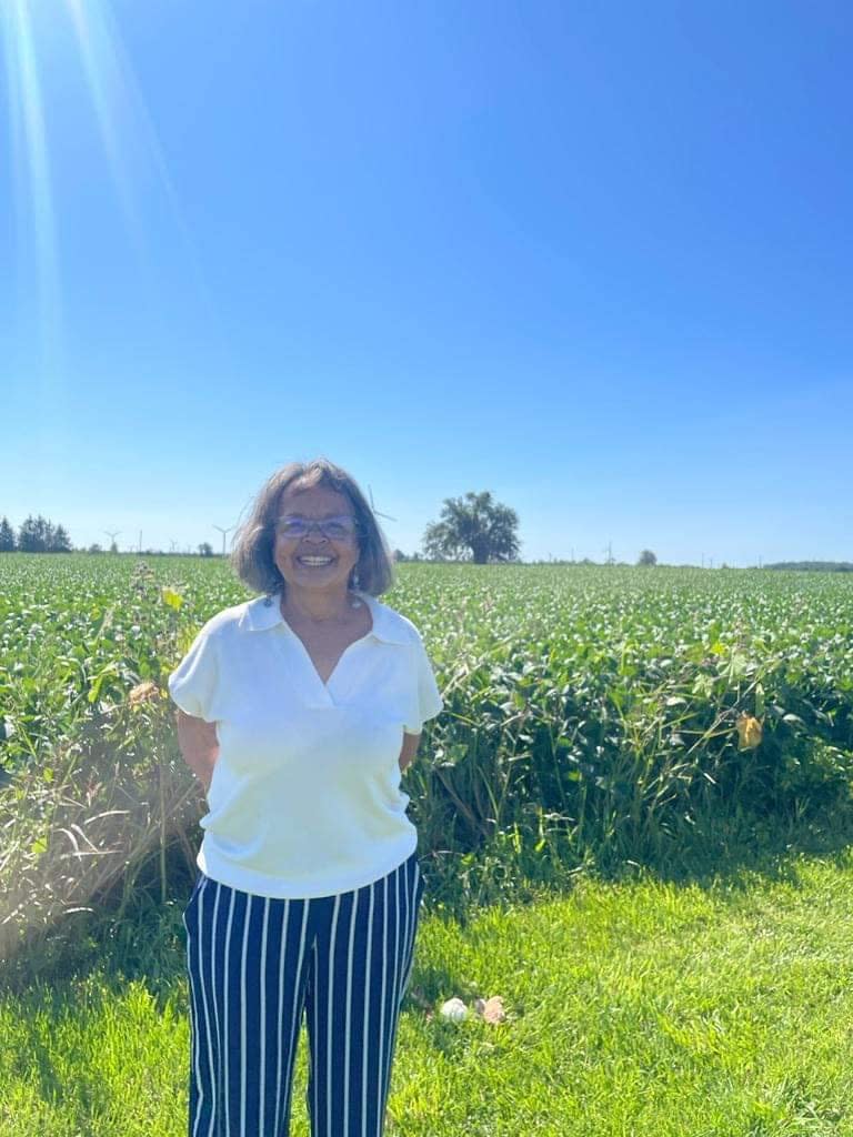 Shannon Prince is a sixth generation North Buxton resident and one of the organizers of the community's 100th annual homecoming celebration. Pictured, Prince is with the pear tree on her father's farm, under which the first ever homecoming took place.  (Meg Roberts/CBC - image credit)