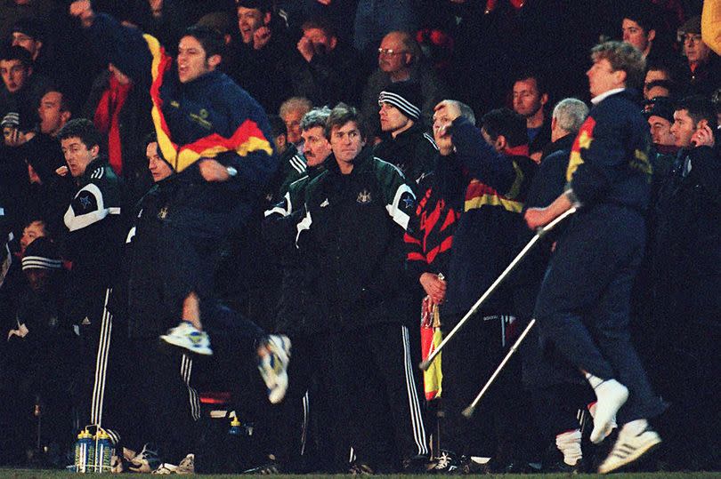 Kenny Daglish the Newcastle manager looks on in disbelief as non league Stevenage celebrate holding his Premiership team to a one all draw at full time