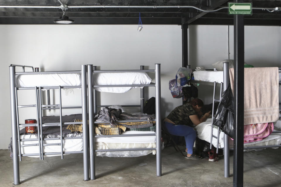 A person checks her cell phone inside a migrant shelter in Ciudad Juarez, Mexico, Monday, June 26, 2023. Unwittingly, migrants in Latin America finance disinformation during their journeys to the U.S., as they fall victim to fraud that can cost them thousands of dollars and that in turn has served to develop new business models, from fake work recruiters to those who call themselves "migration coaches." (AP Photo/Christian Chavez)