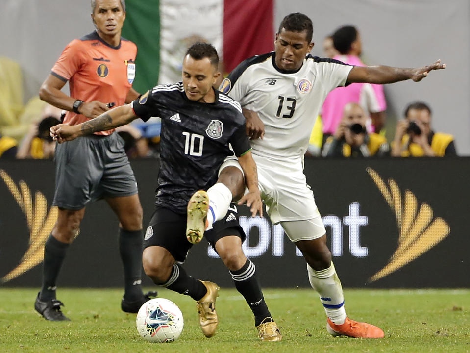 Mexico midfielder Luis Montes (10) works to keep control of the ball from Costa Rica midfielder Allan Cruz (13) during the extra time period of their CONCACAF Gold Cup quarterfinal soccer match Saturday, June 29, 2019, in Houston. (AP Photo/Michael Wyke)