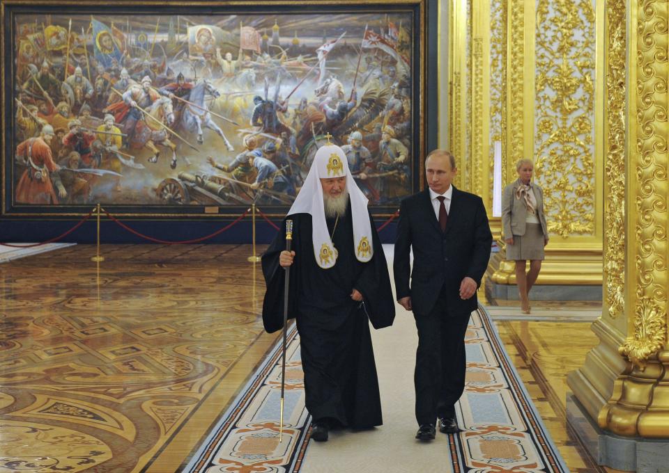 FILE - Russian President Vladimir Putin and Russian Orthodox Patriarch Kirill arrive to attend the gala reception marking the National Unity Day at the Kremlin in Moscow, Russia, Tuesday, Nov. 4, 2014. From the early years of his rule, Putin has repeatedly contended that studying Russian history should make Russians proud of their country. In Russia, history has long become a propaganda tool used to advance the Kremlin's political goals. (Mikhail Klimentyev, Sputnik, Kremlin Pool Photo via AP, File)