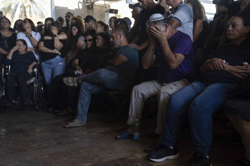 Mourners attend the funeral of the Israeli woman Shiraz Tamam, killed by Hamas militants while attending a music festival at a cemetery in Holon, central Israel, Tuesday, Oct. 17, 2023. (AP Photo/Petros Giannakouris