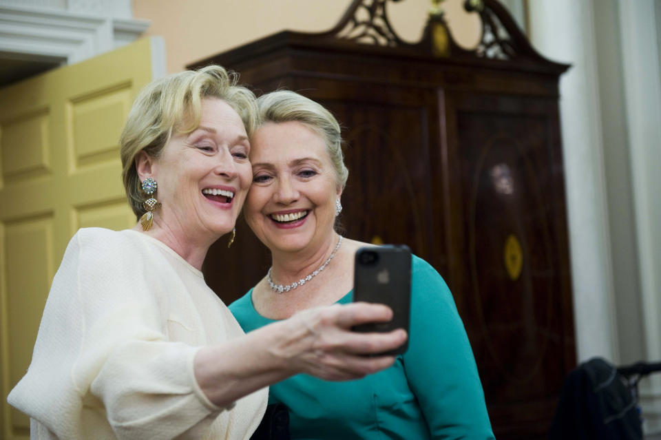 Actress Meryl Streep uses her iPhone to get a photo of her and Secretary of State Hillary Rodham Clinton following the State Department Dinner for the Kennedy Center Honors gala Saturday, Dec. 1, 2012 at the State Department in Washington. (AP Photo/Kevin Wolf)