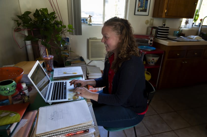 PASADENA, CA - DECEMBER 18, 2020: Seventh grade history teacher Casey Jagusch teaches her students remotely from her kitchen table on December 18, 2020 in Pasadena, California. She realizes some students have been struggling in remote learning and is hoping LA school officials will defer failing grades for students.(Gina Ferazzi / Los Angeles Times)