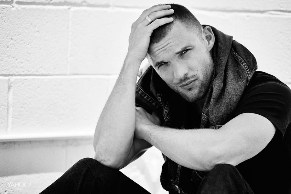 Ed Skrein wraps a denim jacket around his neck.