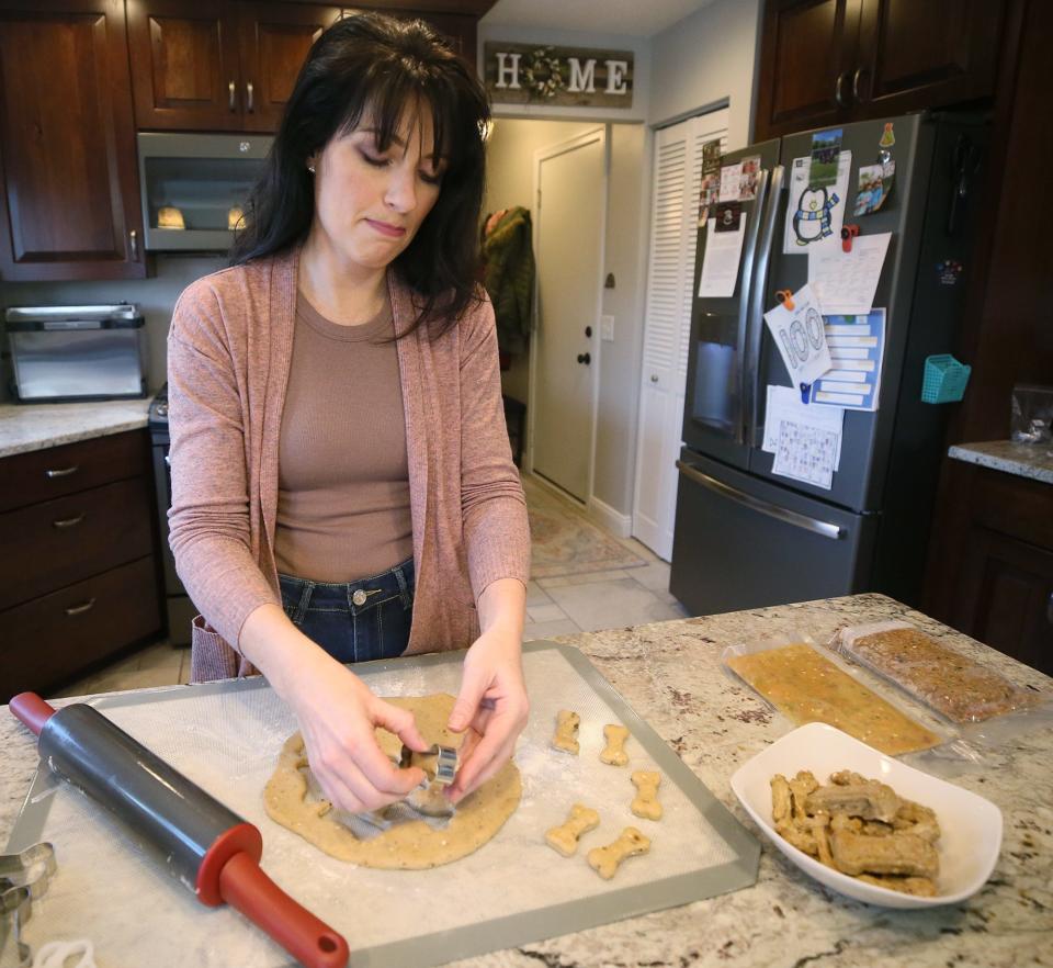 Penny Lansing, owner of Paw-ppy, makes a batch of organic peanut butter treats at her New Franklin home on Thursday.