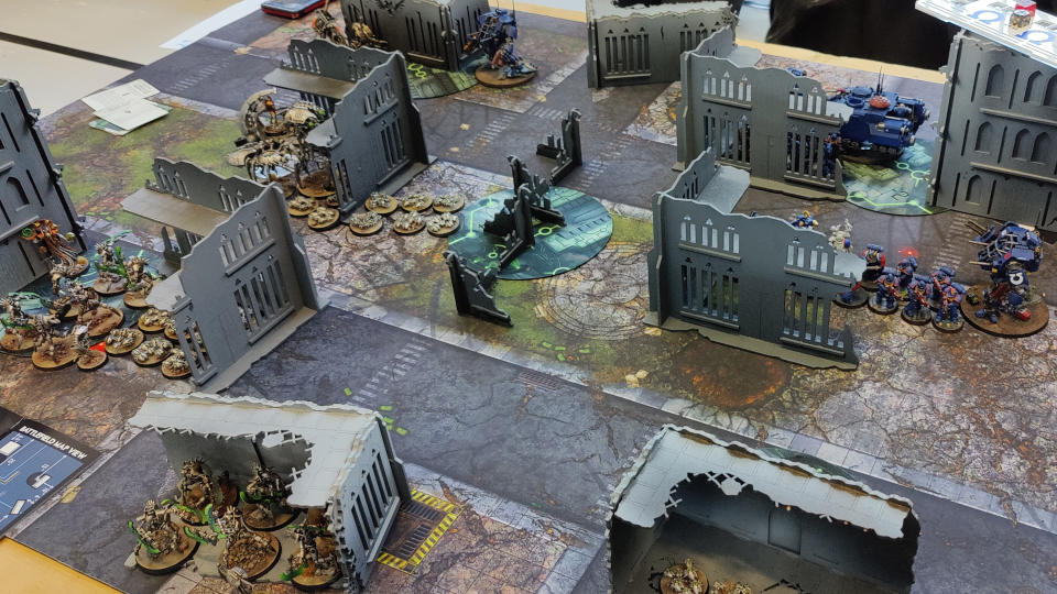 Warhammer 40,000 10th Edition being played on a ruined battlefield