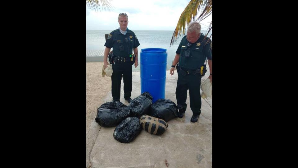 Monroe County Sheriff’s Office deputies stand by a container drum that was full of bags of marijuana Thursday, April 30, 2020.