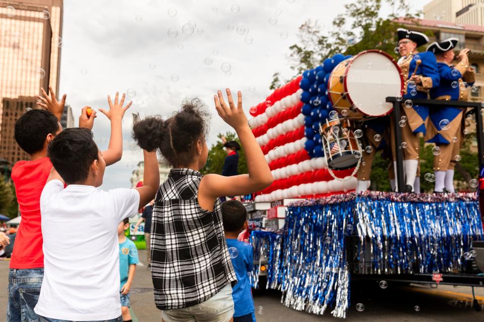 Children jump up to pop bubbles being blown from American Heritage School’s float at the annual Days of ’47 Parade in Salt Lake City on Monday, July 24, 2023. | Megan Nielsen, Deseret News