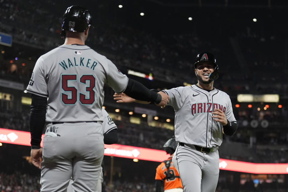 Arizona Diamondbacks' Christian Walker (53) celebrates with Eugenio Suárez after they scored on a double by Gabriel Moreno against the San Francisco Giants during the seventh inning of a baseball game Friday, April 19, 2024, in San Francisco. (AP Photo/Jeff Chiu)