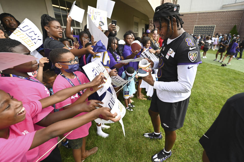 Baltimore Ravens quarterback Lamar Jackson signs autographs after an NFL football training camp practice, Wednesday, July 26, 2023, in Owings Mills, Md. (AP Photo/Gail Burton)