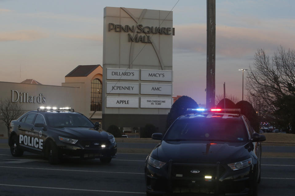 People mill around in the parking lot at Penn Square Mall after police respond to a report of a shooting Thursday, Dec. 19, 2019, in Oklahoma City. One person was shot at the mall during what police are calling a disturbance involving two people. (AP Photo/Sue Ogrocki)