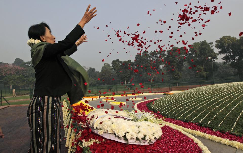 Myanmar's opposition leader and Nobel laureate Aung San Suu Kyi pays floral tribute on the birth anniversary of India's first prime minister Jawaharlal Nehru at his memorial in New Delhi, India, Wednesday, Nov. 14, 2012. Suu Kyi is on a six-day visit to India. (AP Photo/ Manish Swarup)