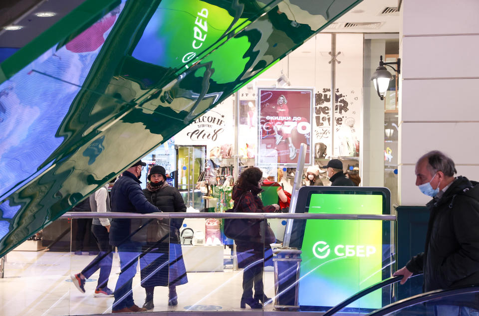 MOSCOW, RUSSIA - FEBRUARY 28, 2022: People queue by a Sberbank ATM machine at the Yevropeisky shopping mall. On February 24, the United States announced it was imposing sanctions on major Russian banks, including Sberbank and VTB in response to the special military operation in Ukraine. According to the Sberbank press office, the bank continues to operate normally, with all transactions associated with mortgages and foreign securities available. Sergei Fadeichev/TASS (Photo by Sergei Fadeichev&#92;TASS via Getty Images)