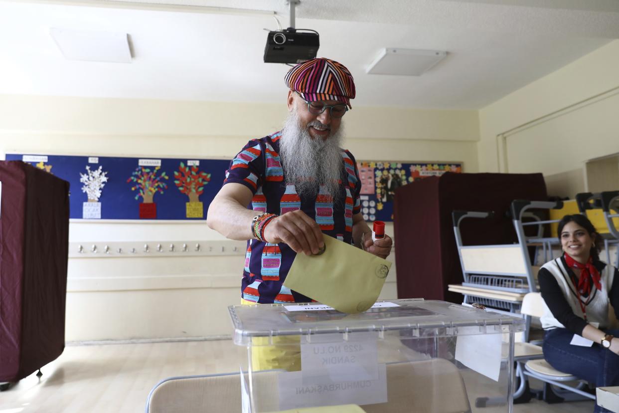 A man votes at a polling station in Ankara, Turkey, Sunday, May 28, 2023. Voters in Turkey are returning to the polls to decide whether the country's longtime leader stretches his increasingly authoritarian rule into a third decade or is unseated by a challenger who has promised to restore a more democratic society. (AP Photo/Ali Unal)