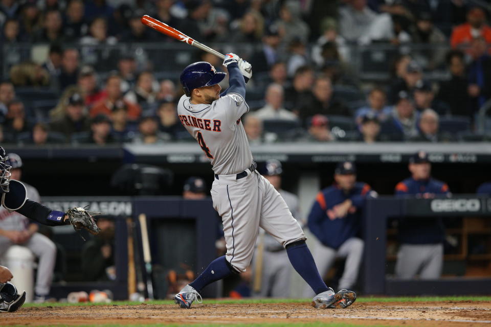 Oct 17, 2019; Bronx, NY, USA; Houston Astros center fielder George Springer (4) hits a three run home run during the third inning against the New York Yankees in game four of the 2019 ALCS playoff baseball series at Yankee Stadium. Mandatory Credit: Brad Penner-USA TODAY Sports