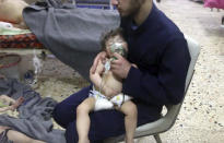 <p>This image made from video released by the Syrian Civil Defense White Helmets, which has been authenticated based on its contents and other AP reporting, shows a medical worker giving toddlers oxygen through respirators following an alleged poison gas attack in the opposition-held town of Douma, in eastern Ghouta, near Damascus, Syria, Sunday, April 8, 2018. (Photo: Syrian Civil Defense White Helmets via AP) </p>