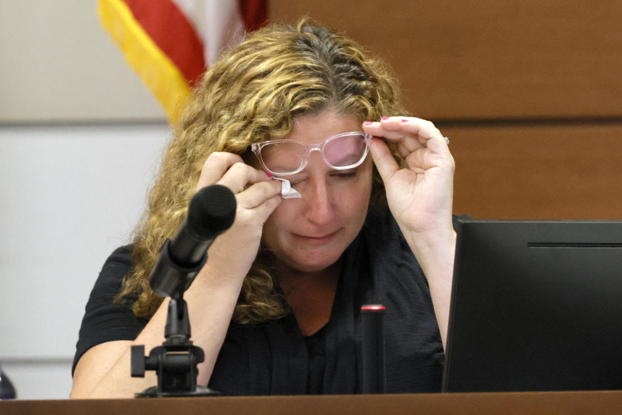 Marjory Stoneman Douglas High School teacher Dara Hass wipes away tears as she testifies in court about the shooting in her classroom during the penalty phase of Marjory Stoneman Douglas High School shooter Nikolas Cruz's trial at the Broward County Courthouse in Fort Lauderdale, Fla., on Tuesday, July 19, 2022. His brother, Nicholas Dworet was also shot, and was killed in the rampage. Cruz previously plead guilty to all 17 counts of premeditated murder and 17 counts of attempted murder in the 2018 shootings. (Mike Stocker/South Florida Sun Sentinel via AP, Pool)