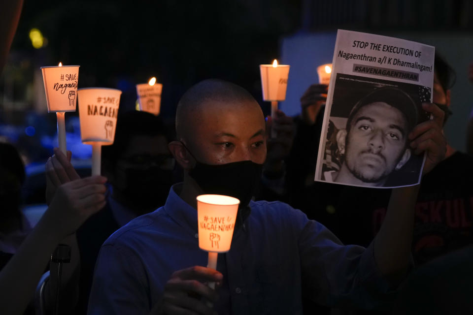 Activists attend a candlelight vigil against the impending execution of Nagaenthran K. Dharmalingam, sentenced to death for trafficking heroin into Singapore, outside the Singaporean embassy in Kuala Lumpur, Malaysia, Monday, Nov. 8, 2021. Singapore's High Court has halted the imminent execution of a Malaysian man believed to have a mental disability, amid pleas from the international community and rights groups. (AP Photo/Vincent Thian)