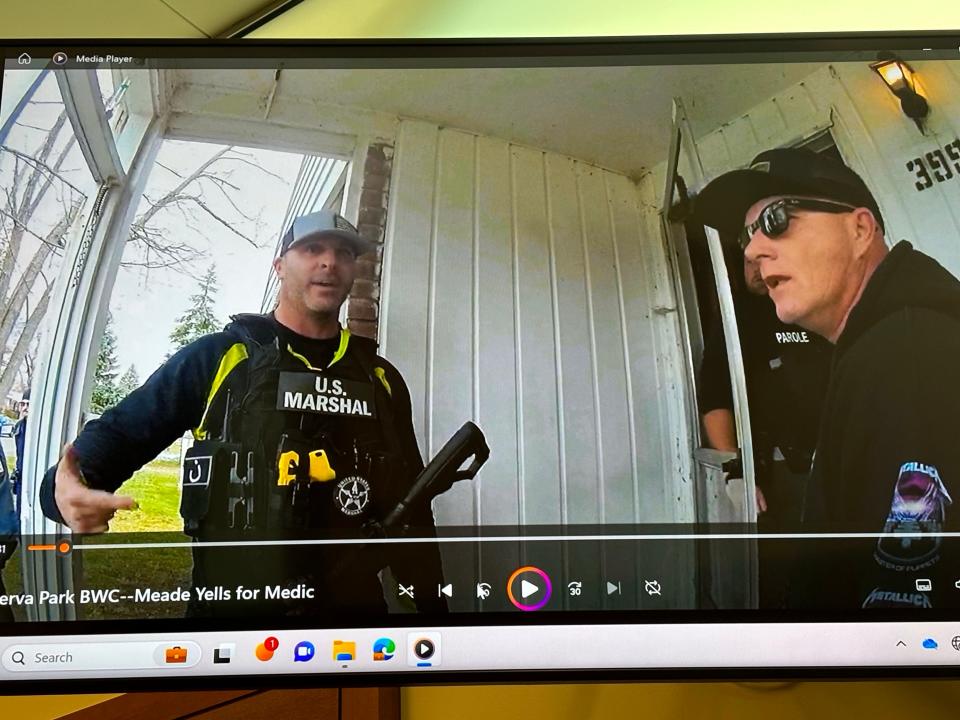 Former Franklin County Sheriff's SWAT deputy Jason Meade, left, is seen on a Minerva Park police officer's body camera footage on Dec. 4, 2020, after Meade fatally shot 23-year-old Casey Goodson Jr. at a side entry door to Goodson's grandmother's house in Columbus' North Linden.