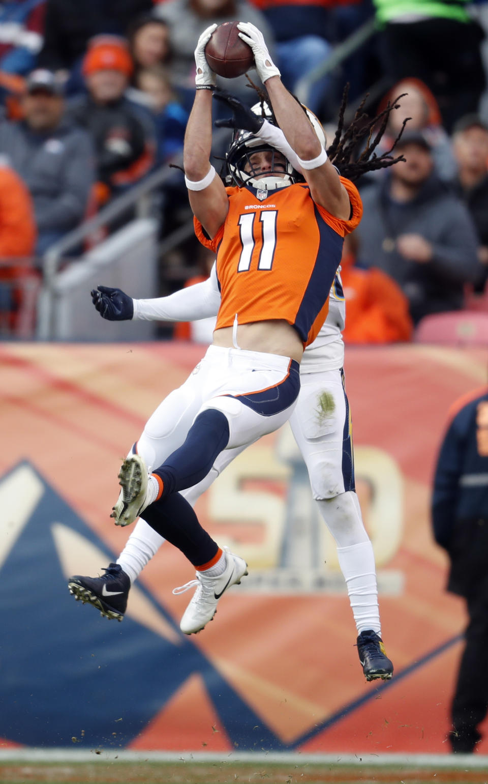 Denver Broncos wide receiver River Cracraft hauls in a pass as Los Angeles Chargers strong safety Jahleel Addae defends during the first half of an NFL football game, Sunday, Dec. 30, 2018, in Denver. (AP Photo/David Zalubowski)