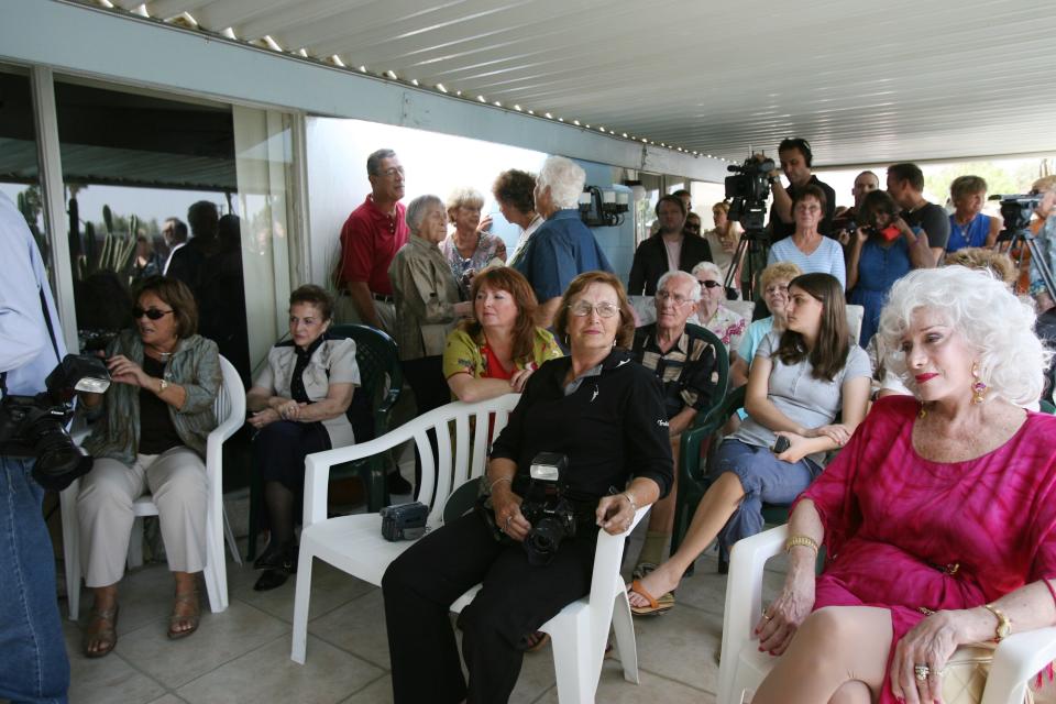 Guests wait for the arrival of Cheeta to celebrate his 75th birthday with his owner, Dan Westfall, on Monday, April 9, 2007, in Palm Springs, Calif. Later research indicated the primate was unlikely to be that old.