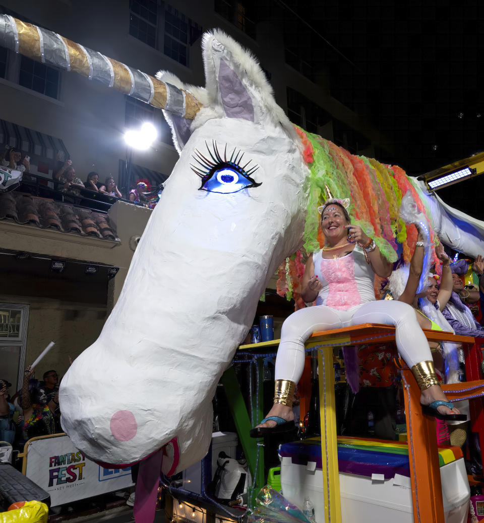 In this Saturday, Oct. 28, 2023, photo provided by the Florida Keys News Bureau, a float depicting a giant unicorn proceeds along Duval Street in Key West, Fla., during the Fantasy Fest Parade. The parade highlighted the subtropical island's 10-day Fantasy Fest costuming and masking celebration, themed "Uniforms and Unicorns," that ends Sunday, Oct. 29. Featuring more than 40 floats and colorful marching groups, it drew tens of thousands of spectators to Key West's historic downtown. (Andy Newman/Florida Keys News Bureau via AP)