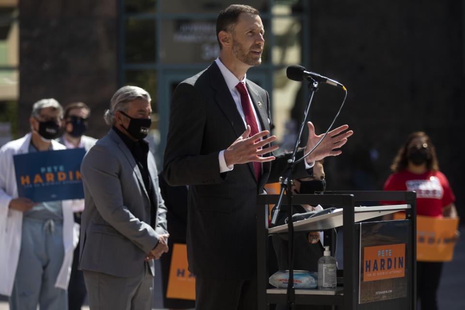 A man speaks at a lectern