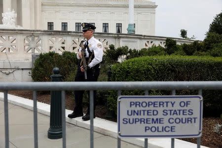 A member of the Supreme Court Police stands guard following the formal investiture of Justice Neil Gorsuch at the Supreme Court in Washington, U.S., June 15, 2017. REUTERS/Aaron P. Bernstein/Files