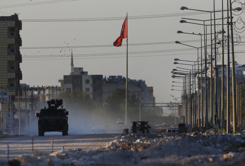 A Turkish police armored vehicle patrols the town of Akcakale, Sanliurfa province, southeastern Turkey, at the border with Syria, Saturday, Oct. 12, 2019. The towns along Turkey's border with northeastern Syria have been on high alert after dozens of mortars fired from Kurdish-held Syria landed, killing several civilians. (AP Photo/Lefteris Pitarakis)