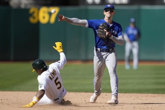 Toronto Blue Jays catcher Danny Jansen (9) gives a forearm bump to