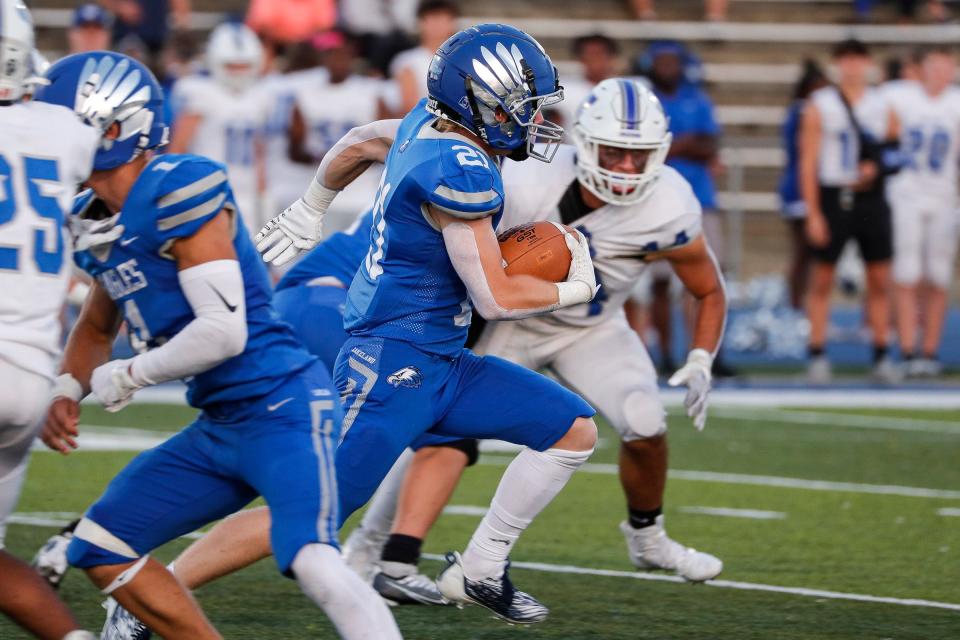 White Lake Lakeland running back Braxton Godin (21) returns a kickoff against Walled Lake Western during the first half at Lakeland High School in White Lake on Friday, Sept. 9, 2022.