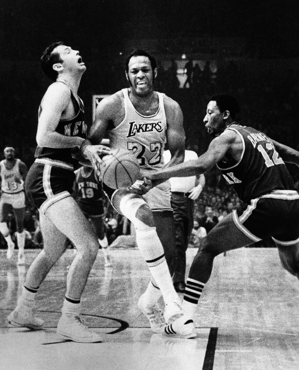 Los Angeles Lakers' Elgin Baylor maneuvers his way through New York Knicks' Bill Bradley