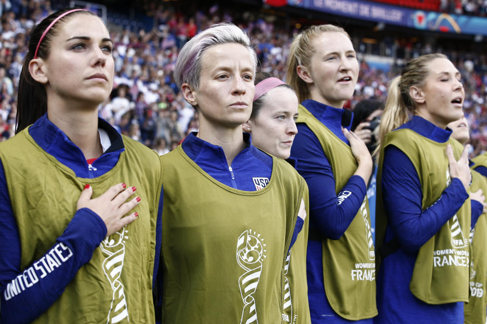 PARIS, FRANCE - JUNE 16: Megan Rapinoe #15 of USA (center) and her teammates are standing for the national anthem during the 2019 FIFA Women's World Cup France group F match between USA and Chile at Parc des Princes on June 16, 2019 in Paris, France. (Photo by Catherine Steenkeste/Getty Images)