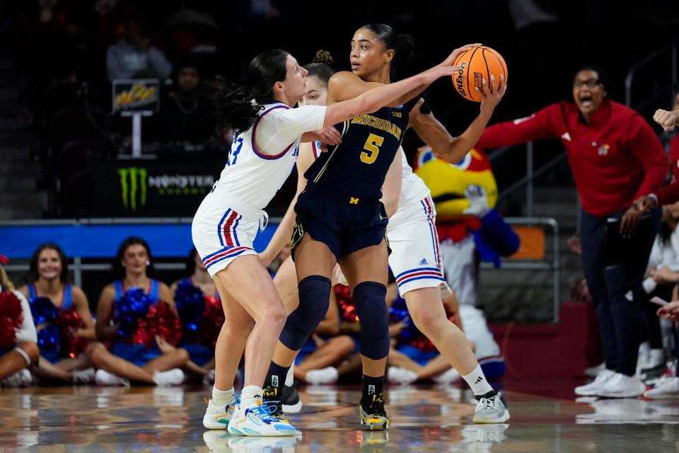 Kansas guard Holly Kersgieter, left, defends against Michigan guard Laila Phelia (5) during a first-round NCAA tournament game at Galen Center in Los Angeles on Saturday, March 23, 2024.