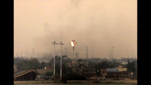 A warplane is shot down over the rebel-held Libyan city of Benghazi. The plane was suddenly spotted with flames coming from the right rear, before it spun down on a residential area south of the city. 