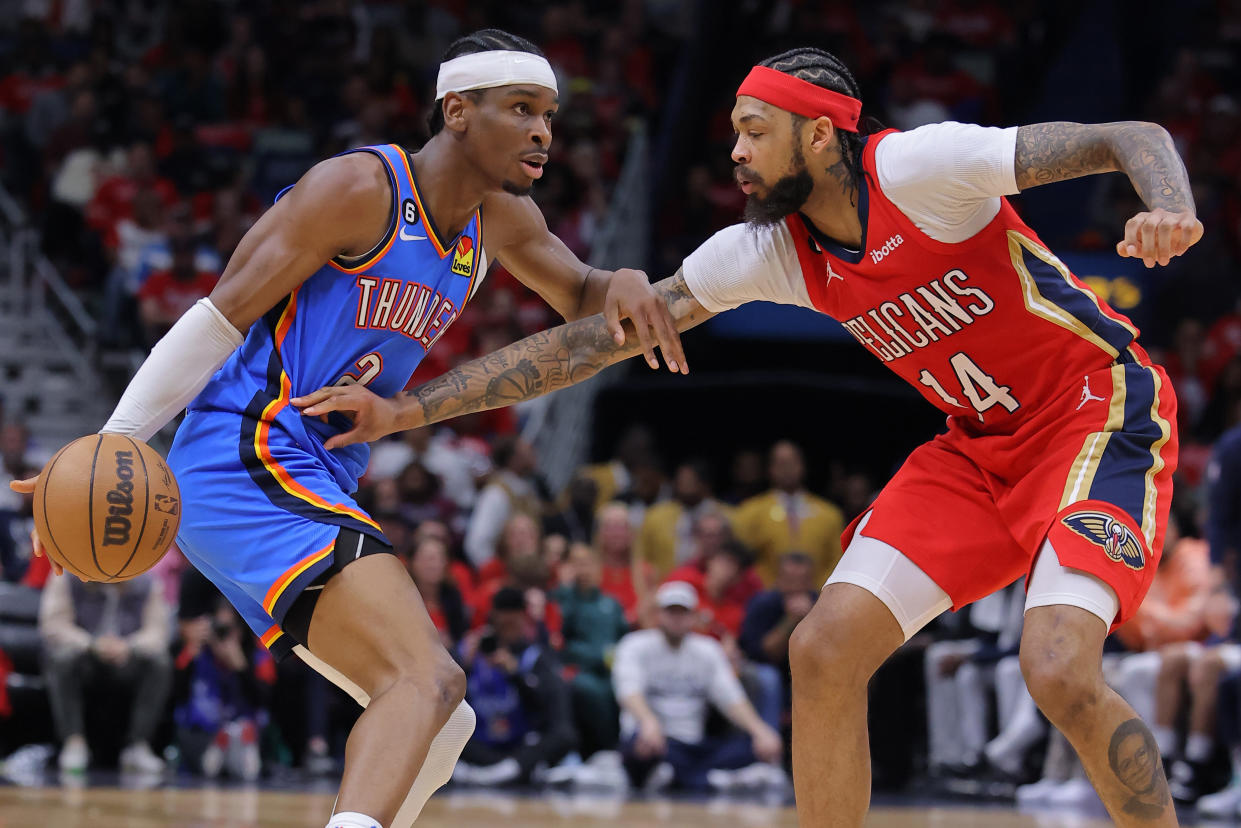 Shai Gilgeous-Alexander of the Oklahoma City Thunder drives against Brandon Ingram of the New Orleans Pelicans during the first half at the Smoothie King Center on April 12, 2023 in New Orleans.