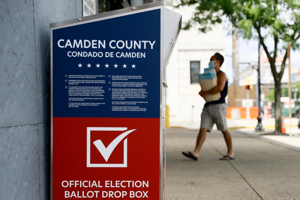 A man walks past a vote-by-mail drop box for the upcoming New Jersey primary election outside the Camden, N.J., Administration Building, Wednesday, July 1, 2020. (AP Photo/Matt Slocum)