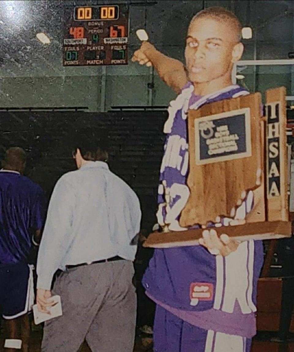 Washington starting guard Robert Williams pointing at the scoreboard after the Continentals defeated Southport for the 1995 sectional title.