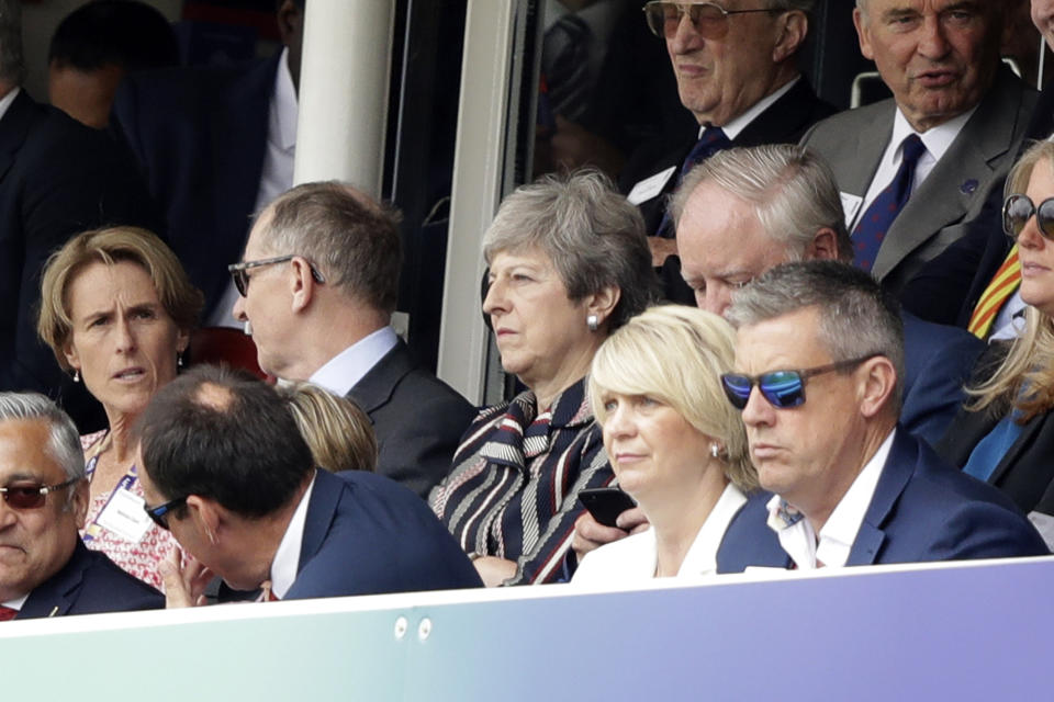 Prime Minister Theresa May sits flanked by her husband Philip during the Cricket World Cup final (AP Photo/Matt Dunham)