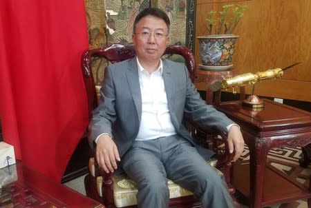 China's ambassador to Kenya Wu Peng poses during an interview with Reuters at the Chinese embassy in Nairobi