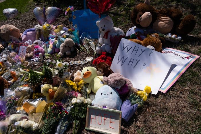 Flowers, balloons, and other items in memory of victims of the mass shooting are left at the entrance of the Covenant School on March 29.